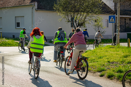 Group of cyclists on city road, street, asphalt