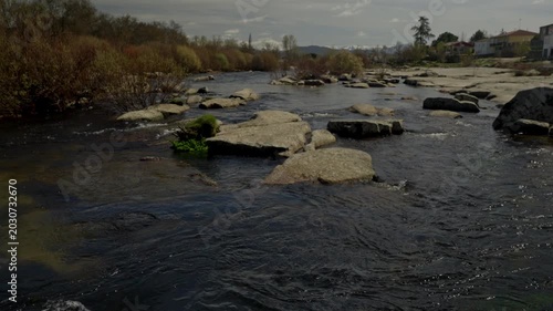 River water flowing gently over large granite rocks