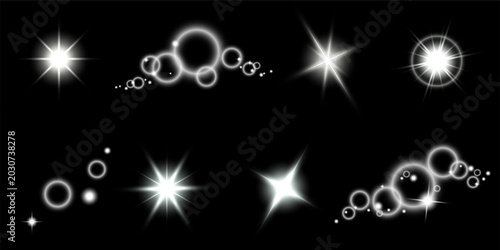 Flashes of light and sparkling starbursts on a black background. Shining sunbeams, glowing solar flares, radiant golden stars, lens flare, glittering cosmic light effects.
