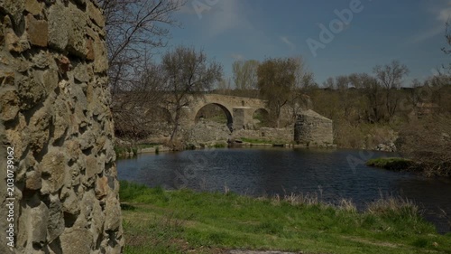 Puente del Congosto ancient stone bridge and calm connecting river creating a...