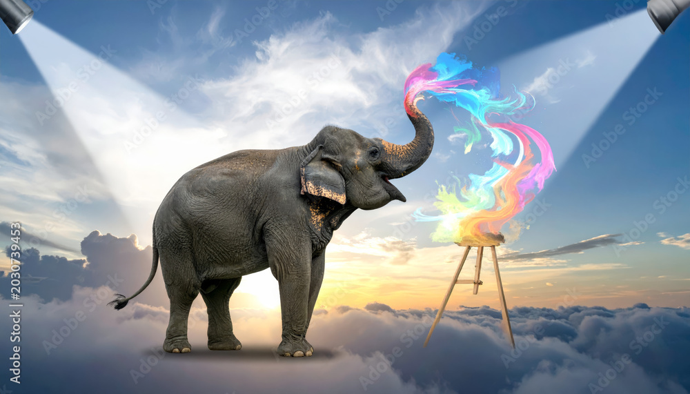 Fototapeta premium An elephant artist uses its trunk to paint a vibrant, colorful masterpiece on a cloud canvas in the sky.