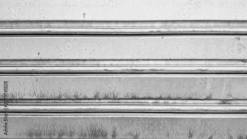 Close-up of a weathered, metallic, corrugated roller shutter or garage door.