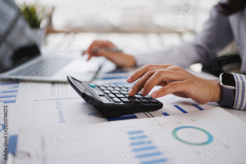 Accounting company provide finance and taxation planning for profitable cash flow, Auditor accountant working in office, analyze financial data and accounting record with calculator.Insight.