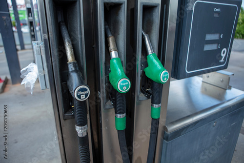 Fuel nozzles at gas station
