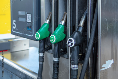 Foto Fuel pump at the gas station, close-up of fuel nozzle