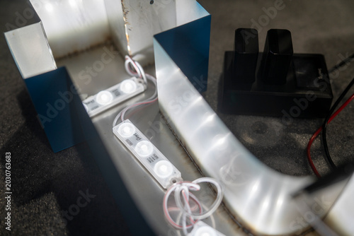 Foto Close-up of illuminated blue acrylic channel letter signage with LED lighting du