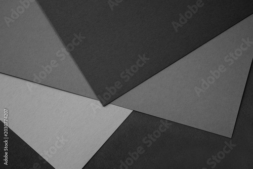Abstract layered gray paper background with textured geometric shapes for min...