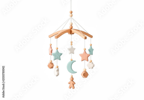 A baby mobile with wooden stars, moon, and toys in pastel colors hanging from a transparent background