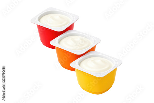 Three vibrant plastic yogurt cups, creamy white dairy product, healthy snack, fresh breakfast food isolated PNG with Transparent Background