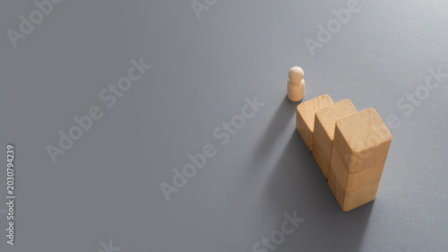 Bild auf Leinwand Minimalist wooden peg figure symbolising career progression, succession planning, employee development, promotion opportunities and professional growth