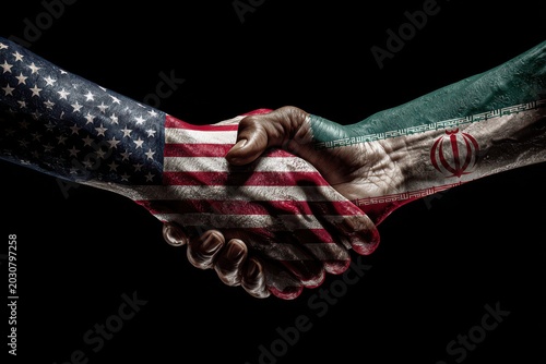 Diplomatic handshake between united states and iran flags painted on hands against black.