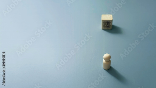 Tableau sur toile Minimalist conceptual image showing a single wooden peg figure facing an artificial intelligence cube on a clean blue background