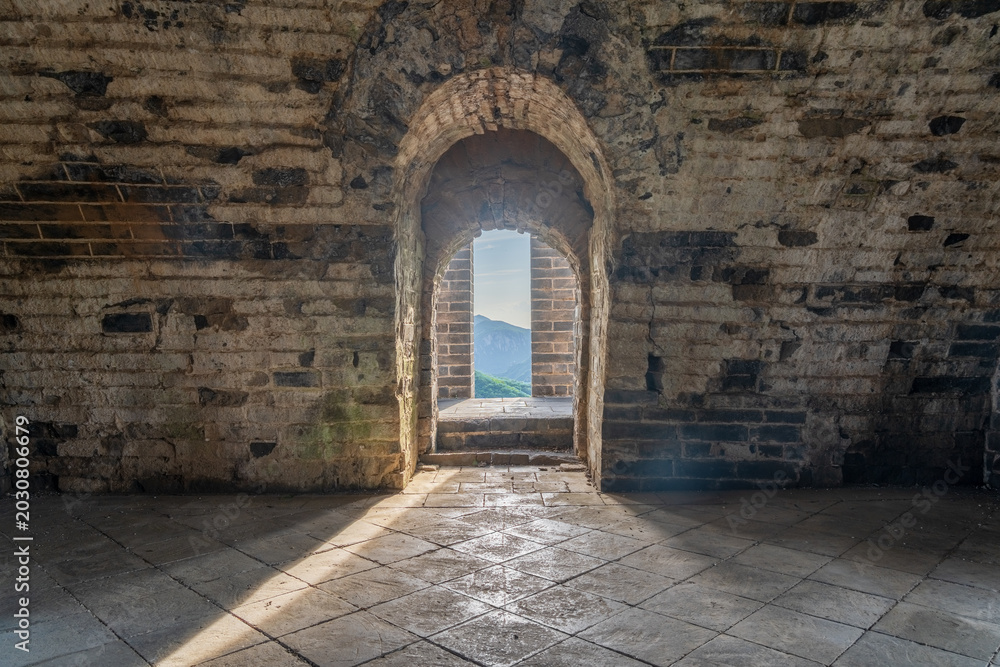 Fototapeta premium Historic Echoes Dramatic Sunbeams Piercing Through Arrow Slits Inside Jiuyan Watchtower