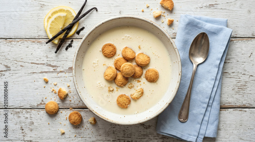 Koldskal Danish Buttermilk Soup with Kammerjunkere Biscuits on Rustic Table