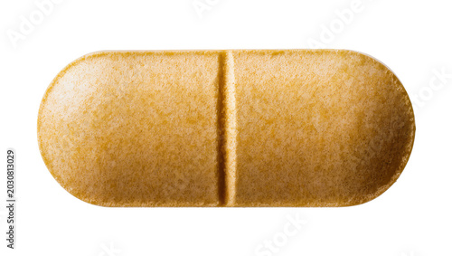 Fotografi Oval yellow vitamin pill with dividing line