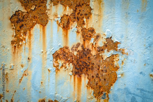 Tableau sur toile Rusty metal texture with peeling paint and corrosion stains creating an abstract industrial background design