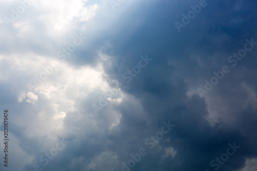 Gray rain clouds and blue sky in summer day.