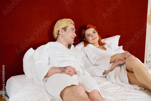 Vászonkép Young couple enjoys a blissful vacation in a modern hotel room together