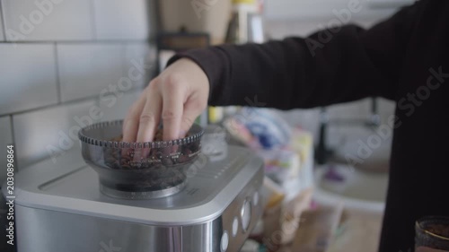 Pouring Coffee Beans into Grinder in Home Kitchen