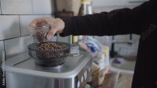 Pouring Coffee Beans into Home Coffee Grinder