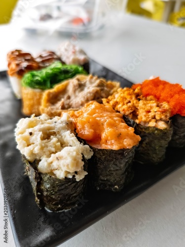 High angle view of sushi set in a black plate.