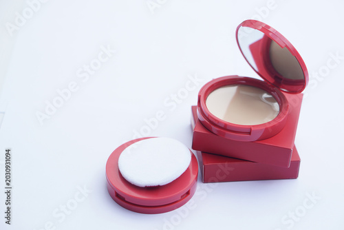 Canvas Print Elegant compact powder foundation with soft applicator puff and mirror in stylish pink packaging, arranged on a clean background