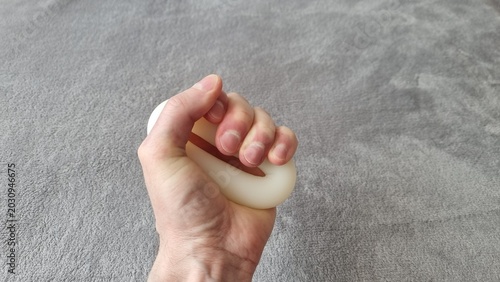Bild auf Leinwand Hand Squeezing Hand Grip Strengthener Expander Close-Up