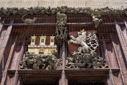 Schilderij op canvas Historic carved coat of arms on wooden façade