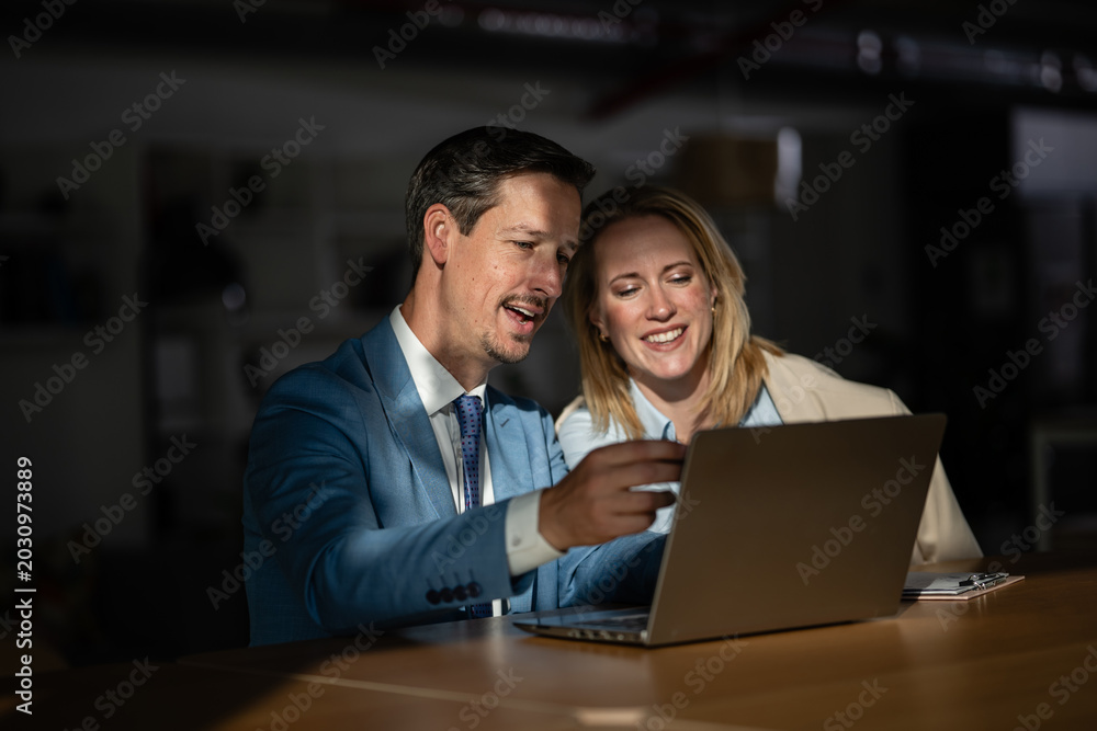 Fototapeta premium Business colleagues collaborating on laptop in office meeting