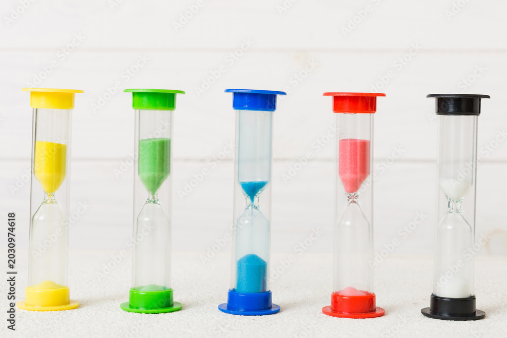 Fototapeta premium hourglass on the table, sand clock as time passing concept for business deadline, copy space