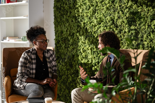 Business colleagues discussing ideas in a modern office lounge