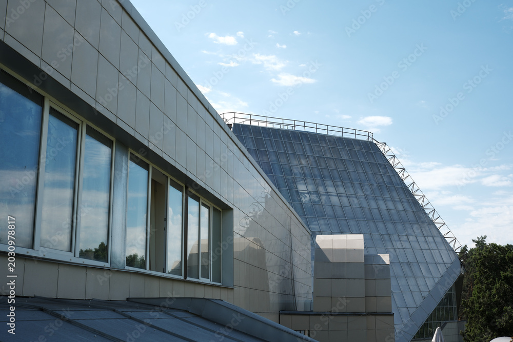 Fototapeta premium Modern architecture shines under a bright blue sky in the city