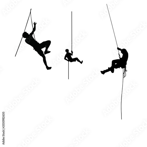 Photos Action silhouettes of rescue workers or mountaineers climbing up and rappelling down ropes