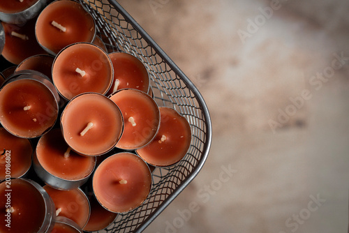 Bild auf Leinwand Brown Tealight Candles in Metal Basket, Cozy Decorative Background with Copy Spa