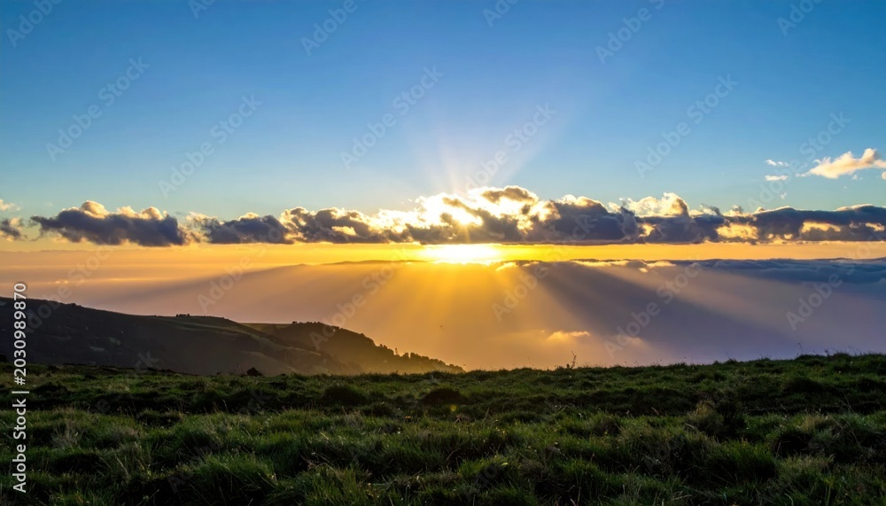 Obraz premium Sunrise Over Mountainous Landscape With Dramatic Cloud Formations.