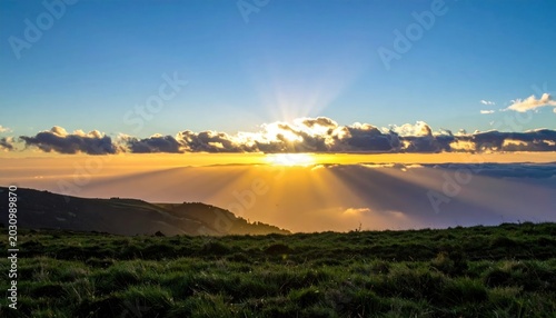 Sunrise Over Mountainous Landscape With Dramatic Cloud Formations.