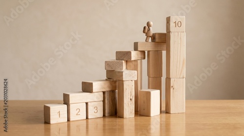 Toy Figure Climbing Numbered Blocks Staircase to Number 10 Tower