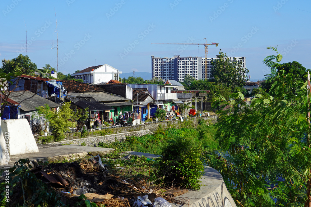 Fototapeta premium Urban canal flowing through a residential neighborhood