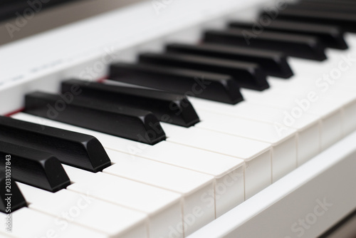 Closeup of white electric piano keys. Piano keyboard.