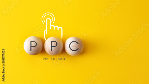 PPC Pay Per Click Marketing Concept with Wooden Letters on Yellow Background