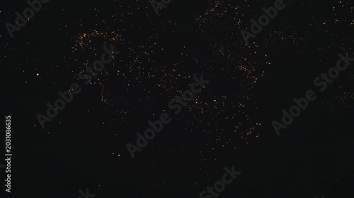 Abstract glowing particles trail in a wave shape, fire sparks or golden dust particles floating in the dark, magical light effect