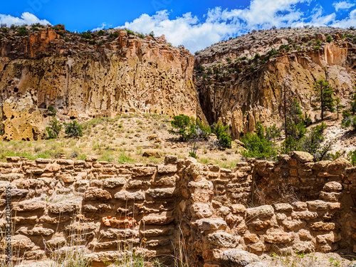 Tableau sur toile Bandelier, New Mexico - May 6, 2026: Ruins of Puebloan homes near the cliffs whe