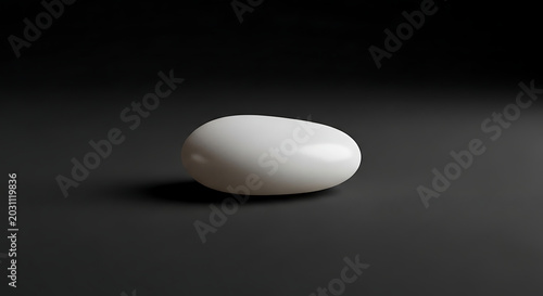 Smooth white pebble stone on dark background