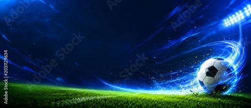 Futuristic Soccer Ball on Grass with Blue Energy Trail and Stadium Lights