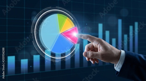 Businessman analyzing colorful pie chart on virtual screen with finger