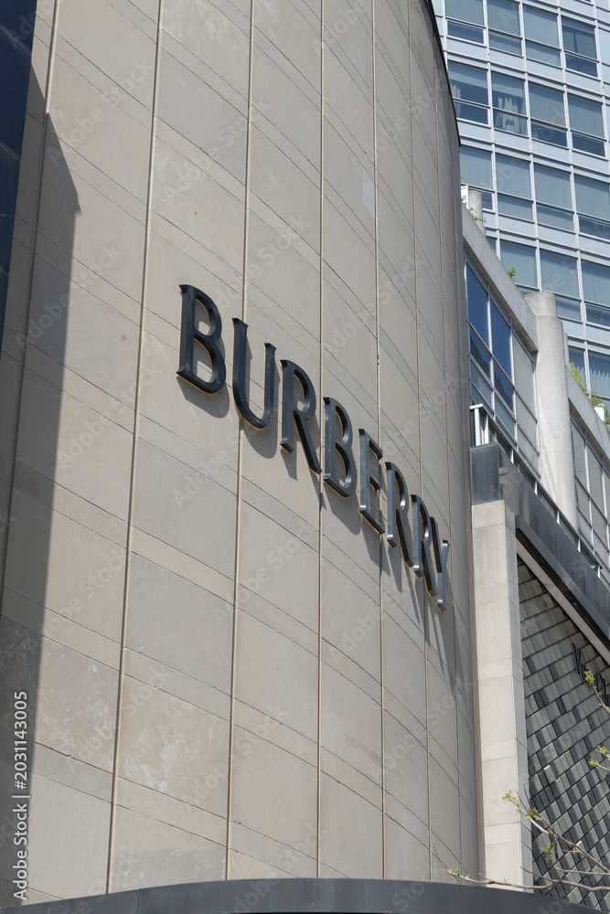 Naklejka premium oblique angle view of facade and sign of Burberry, a clothing store, located here at 144 Bloor St W, Toronto
