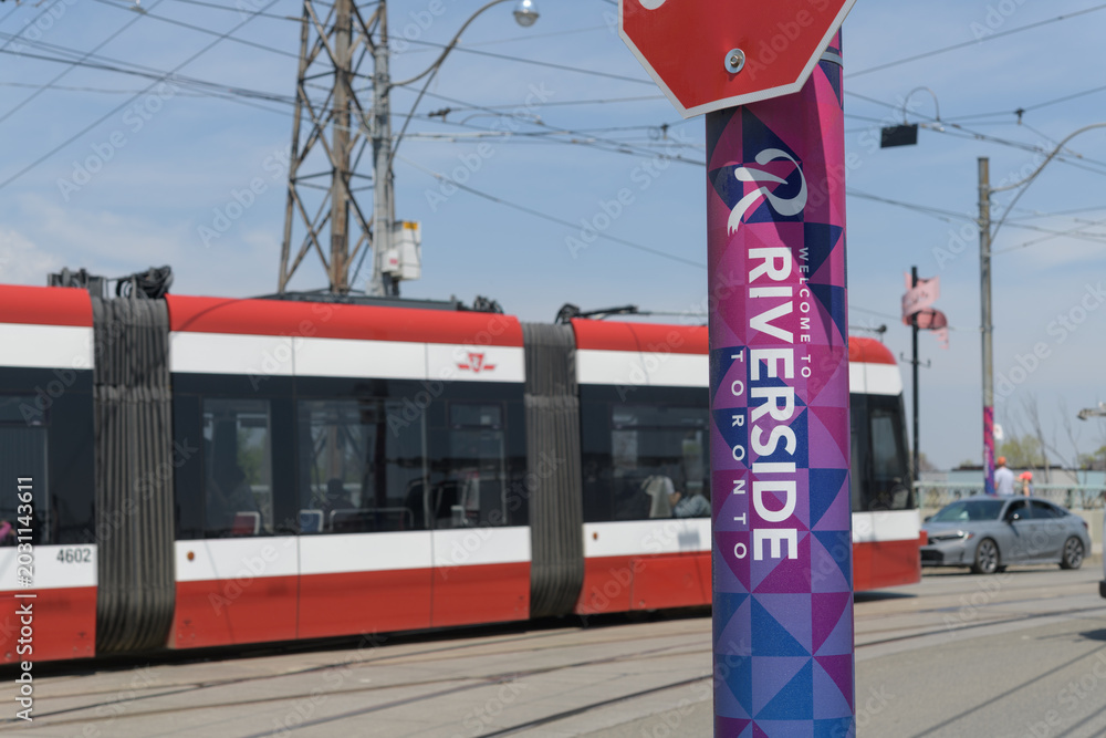Naklejka premium welcome to Riverside BIA promotion wrap on pole with trolley, near Queen Street Viaduct, about 578 Queen St E, Toronto 