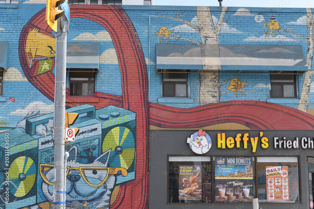 Naklejka premium mural and sign on the side of Heffy's Fried Chicken, a restaurant, located at 1054 Kingston Rd (at Victoria Park Av), Scarborough, Toronto