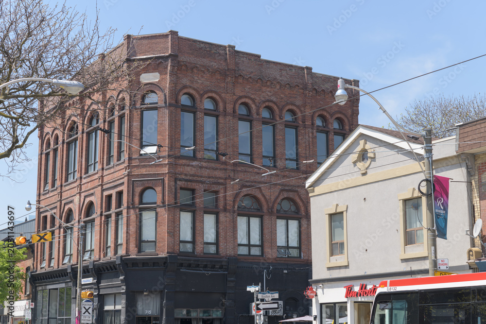 Naklejka premium wide view of Poulton Block (Orient Hall Masonic Lodge), designed by Kennedy, Gaviller & Holland, 1886, 792 Queen St E, Toronto (St Mary Pharmacy/Tim Hortons, at Boulton Av)
