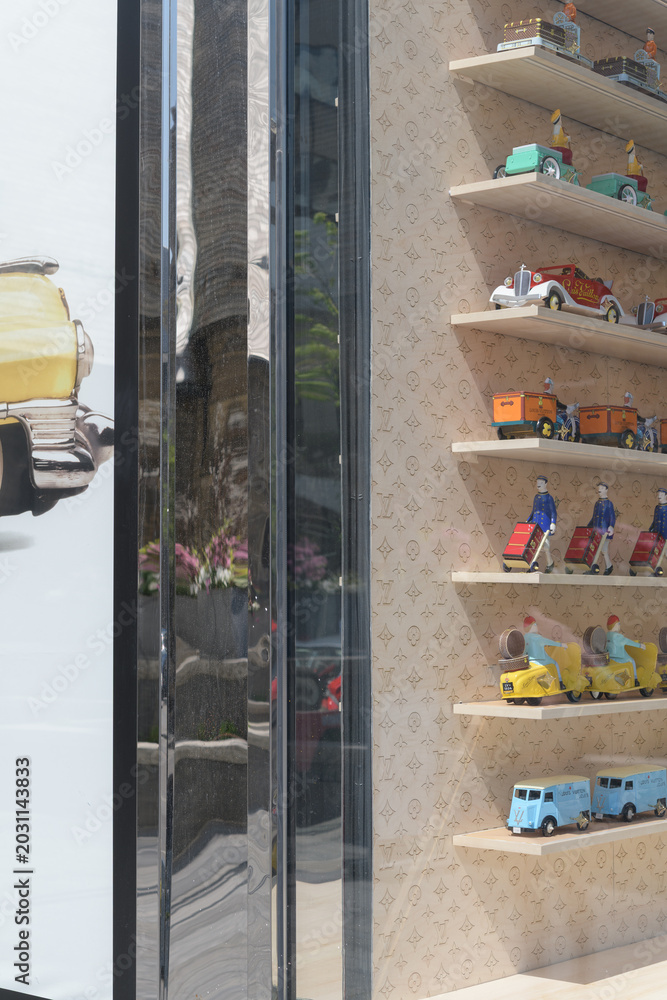 Naklejka premium neat rows of toys in display window at Louis Vuitton, a luxury leather goods store, located at 150 Bloor St W, Toronto